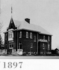 two-storey schoolhouse that looks like a large house, text underneath reads 1897